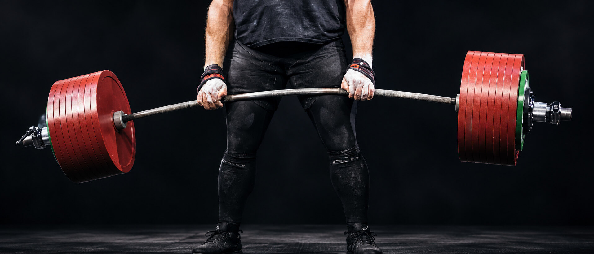 Lifter holding a loaded barbell at lockout